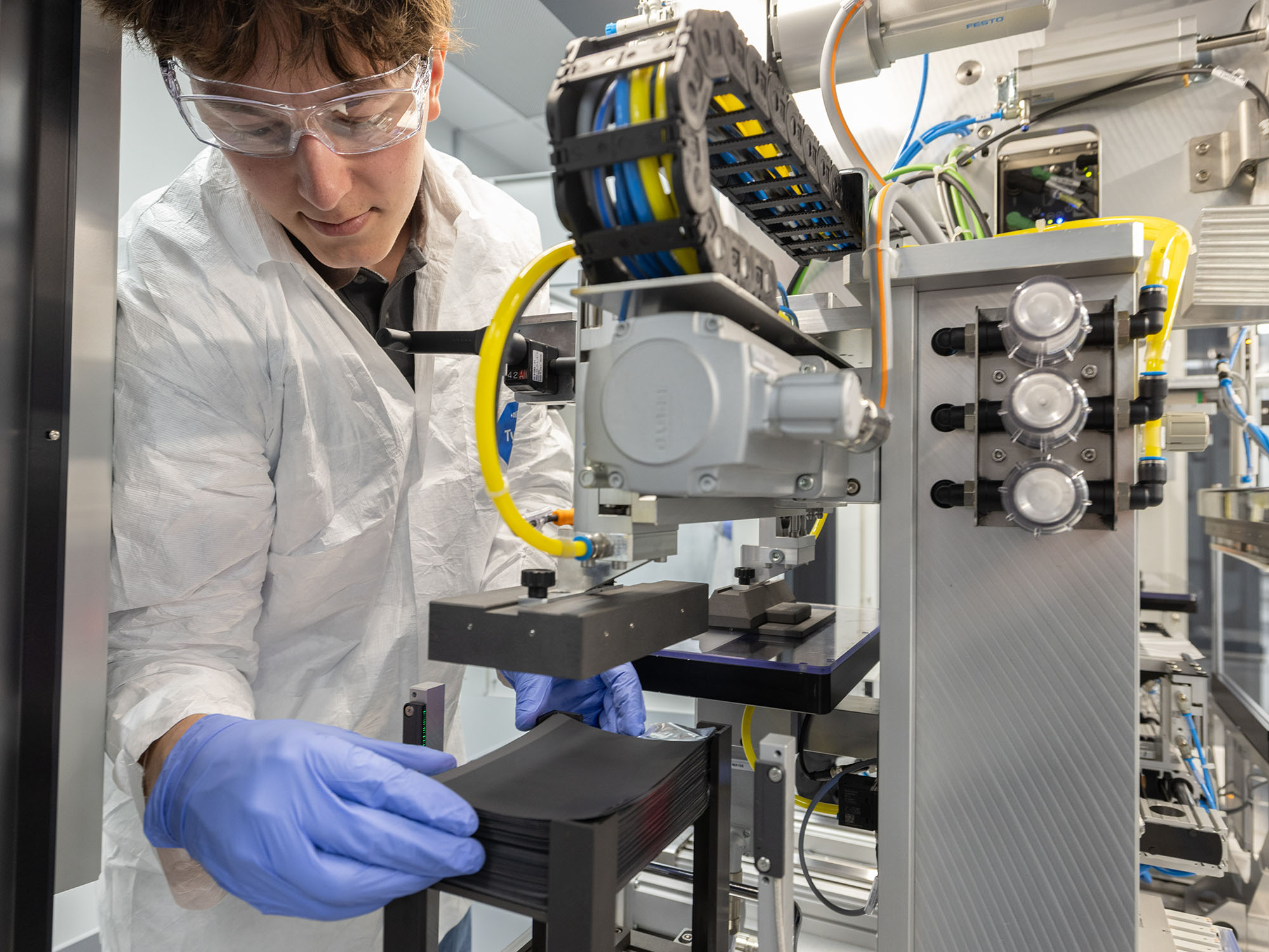 A student works on a device in a battery lab