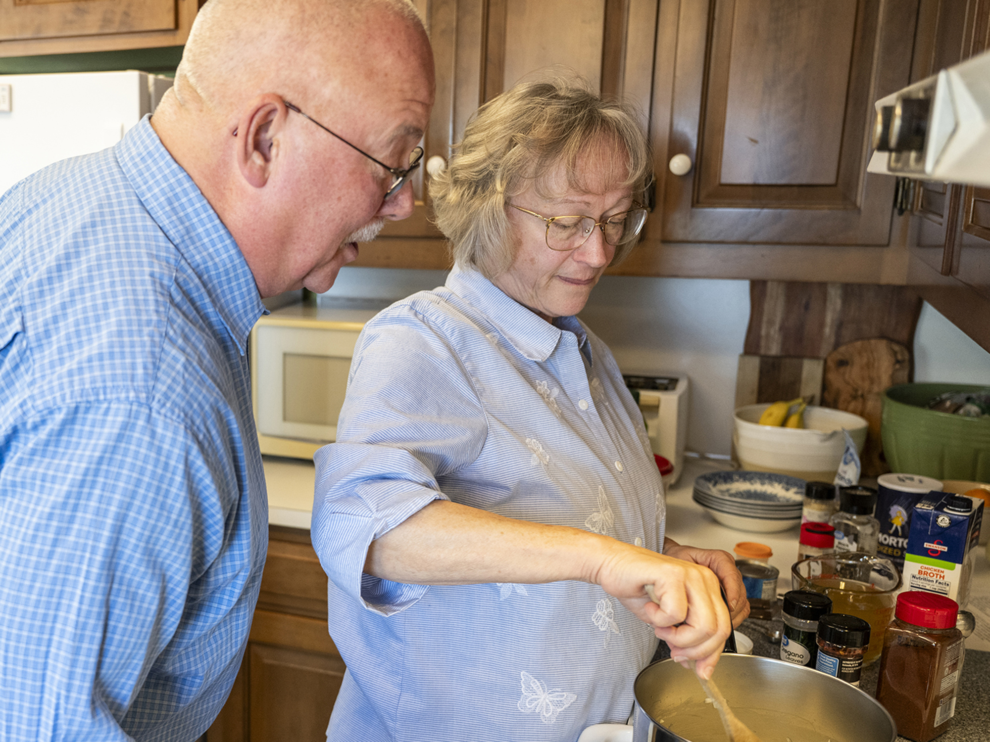 A wife and husband work together in their kitchen