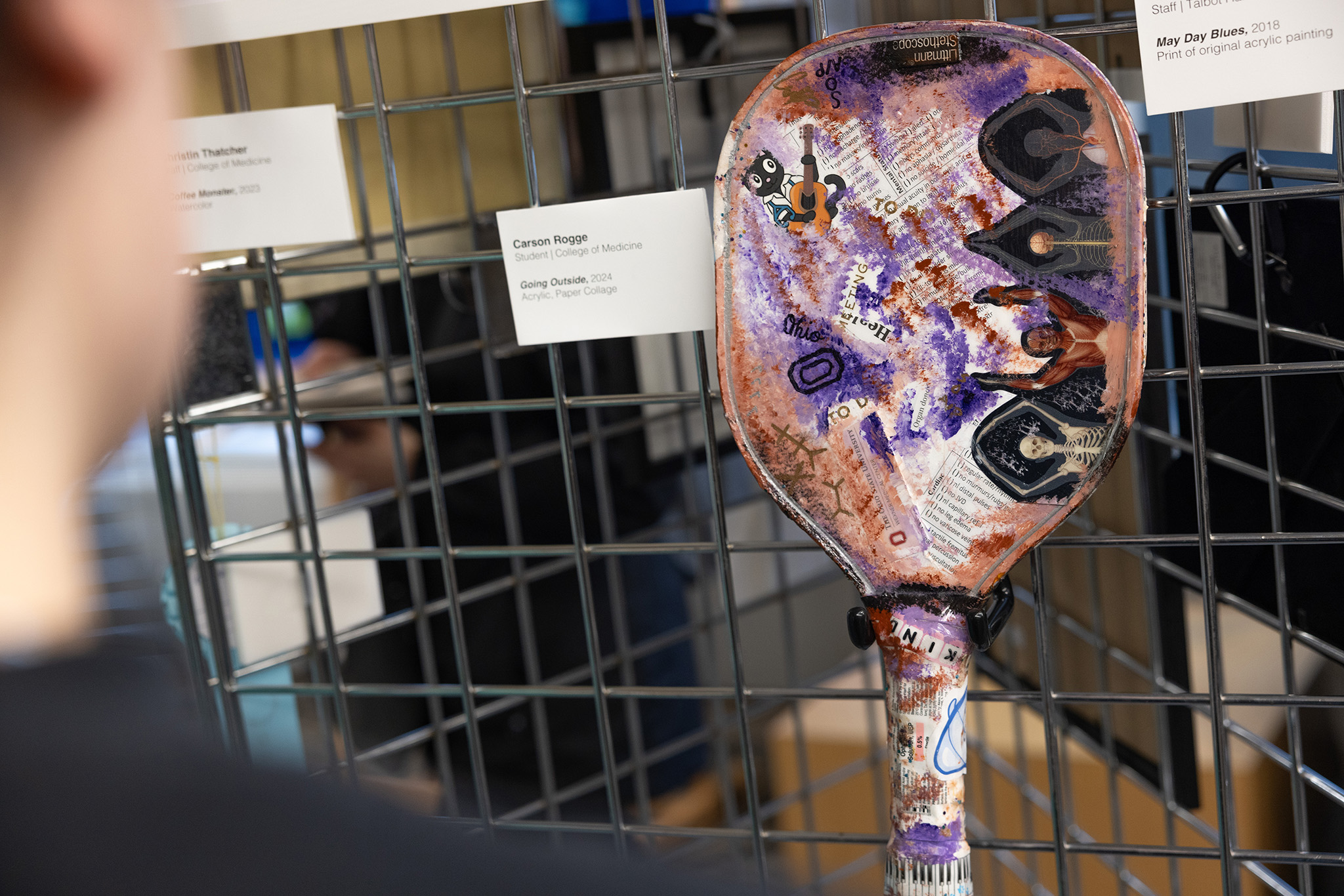 Mixed media paper and paint on a paddle