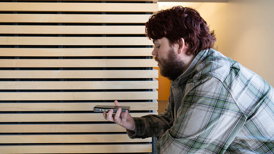 A student speaks into his phone