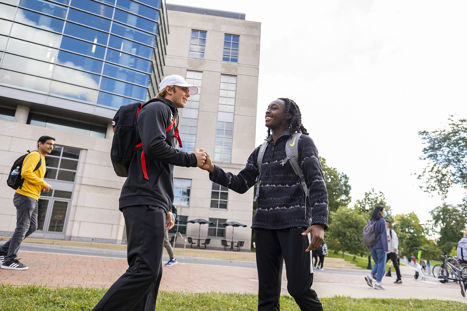 Students shaking hands in front of the Ohio State University library