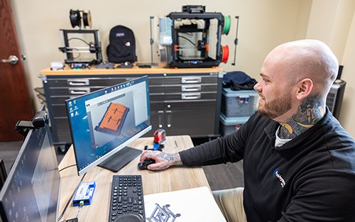Ohio State engineering technology graduate Zach Ernest works at a computer