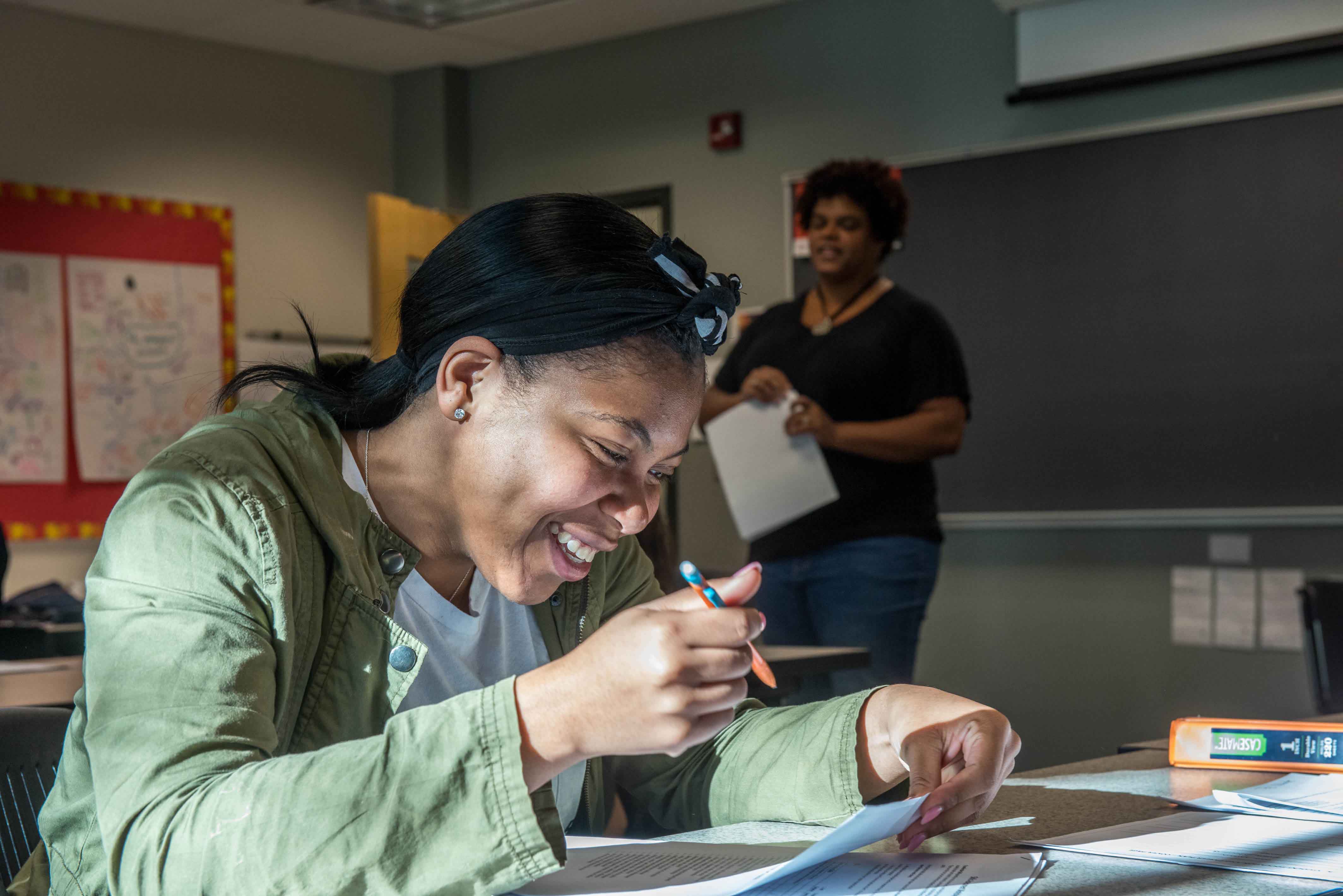 Student looking at papers in a classroom