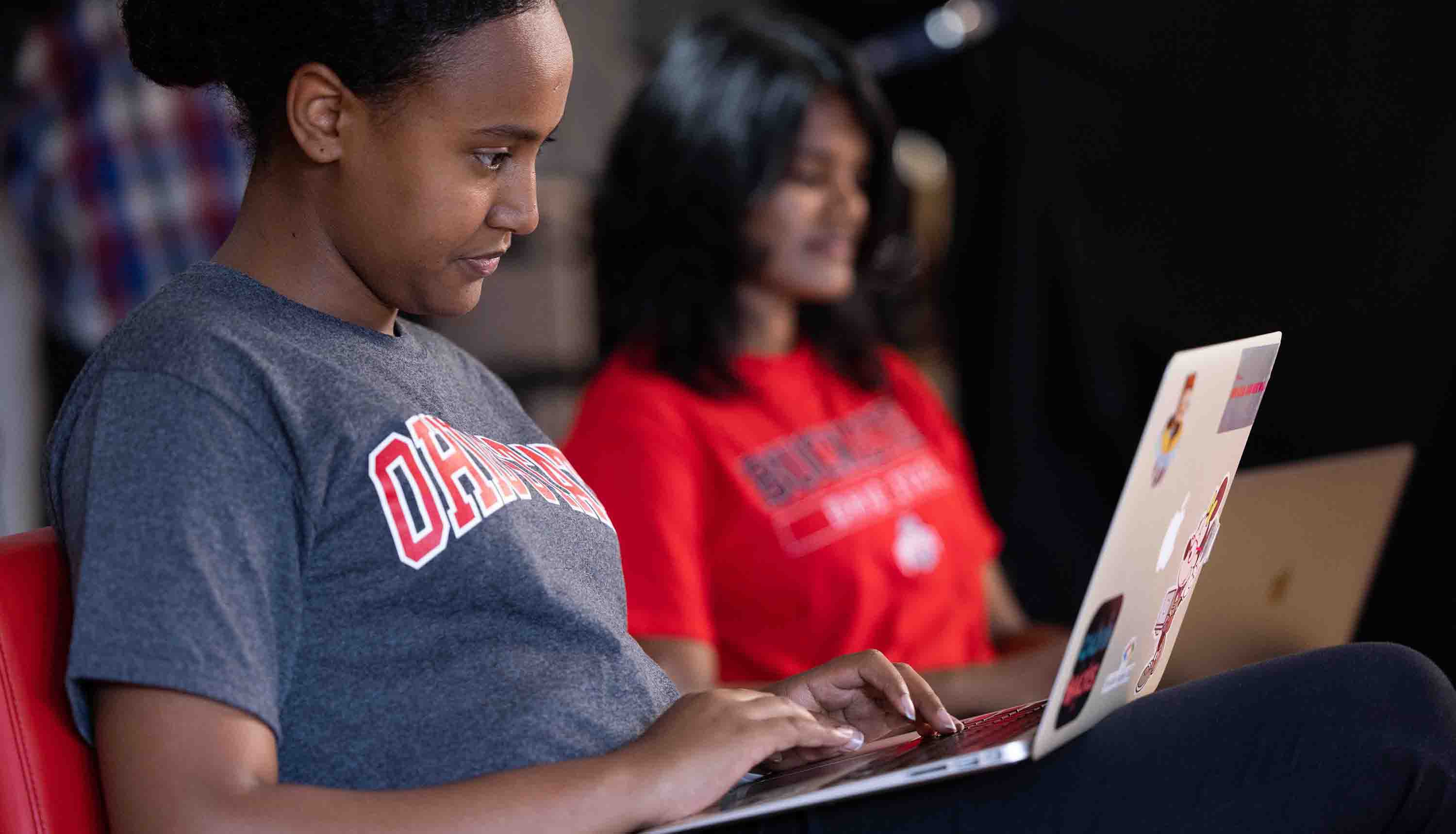 Student using a laptop in a class