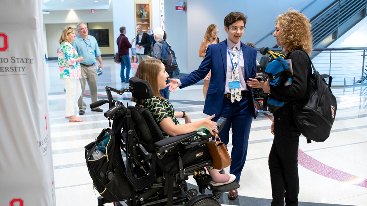 Anna Voelker (center) speaks with two presenters at SciAccess, a conference she hosted at Ohio State that was dedicated to improving accessibility to science.