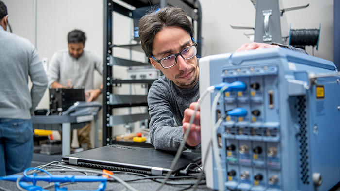 Graduate students in STEM fields and Engineering in labs at the Center for Automotive Research