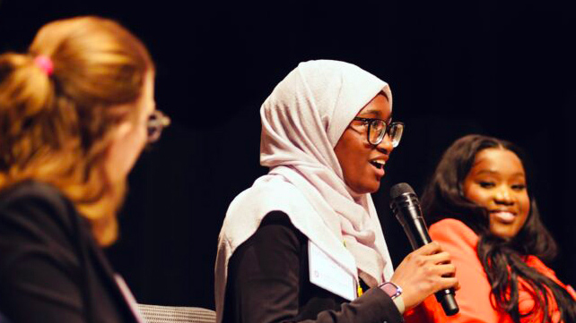 A woman speaking into a microphone