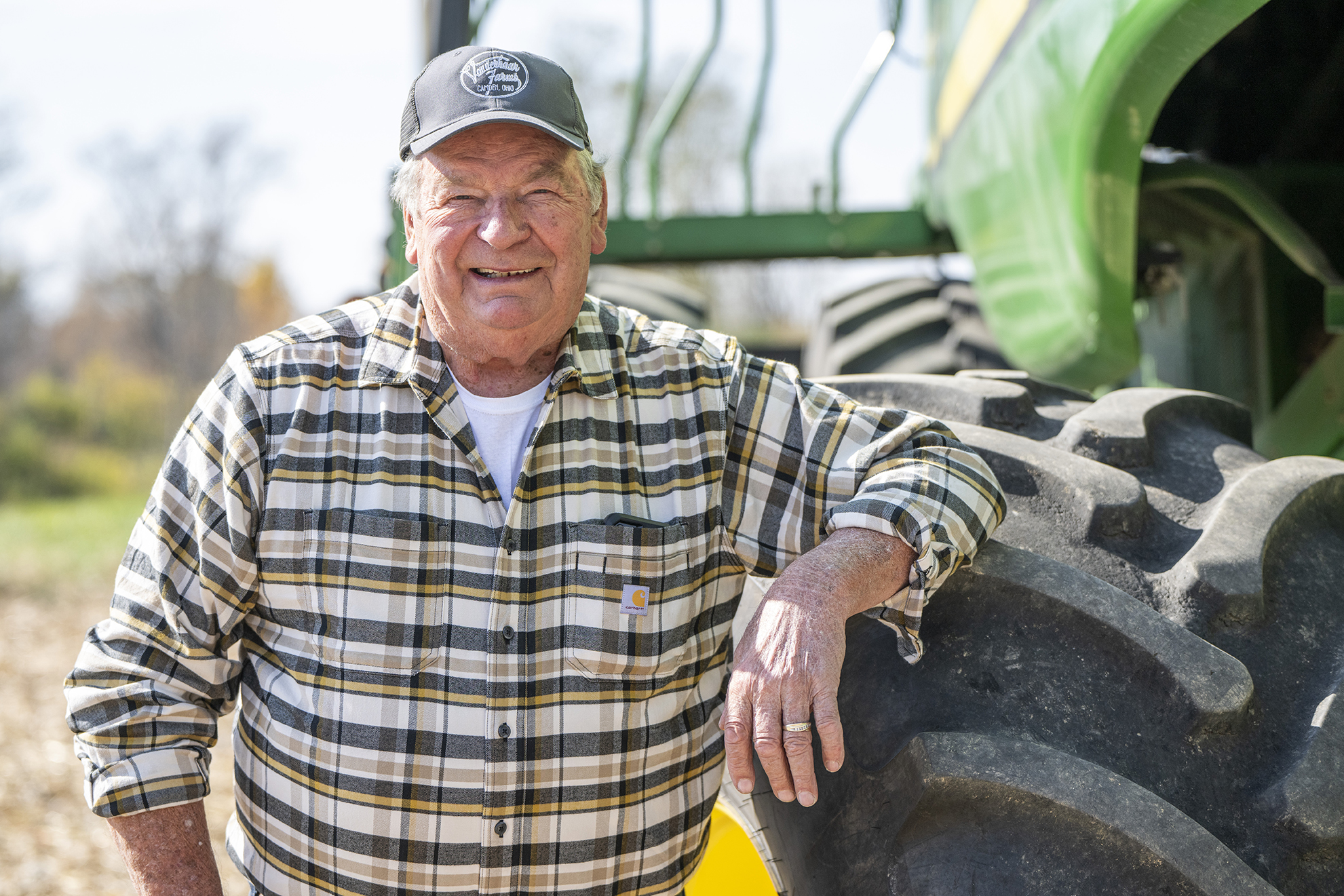 Ohio farmer Len Vonderhaar stands next to his combine.