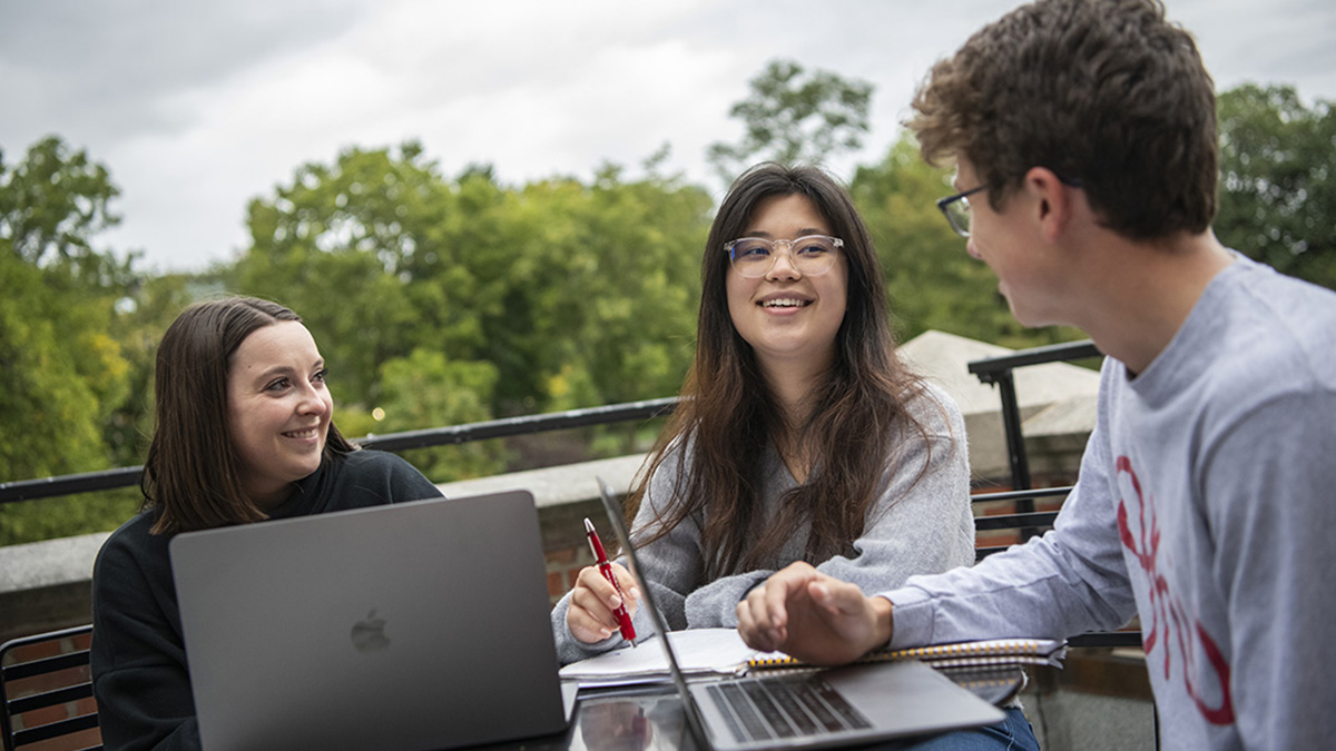 Students sit at a table talking
