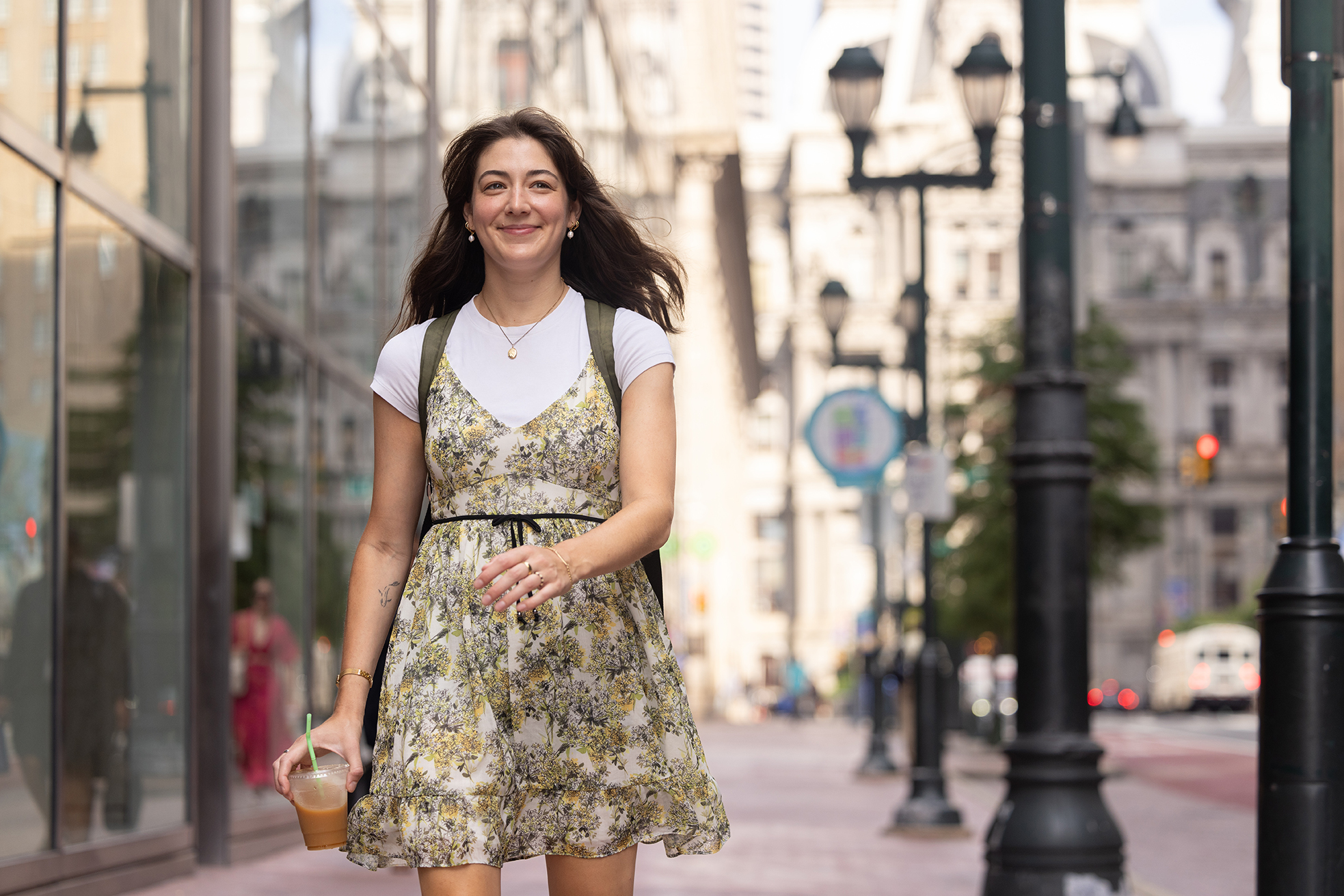 A young woman walks down the street in an urban environment