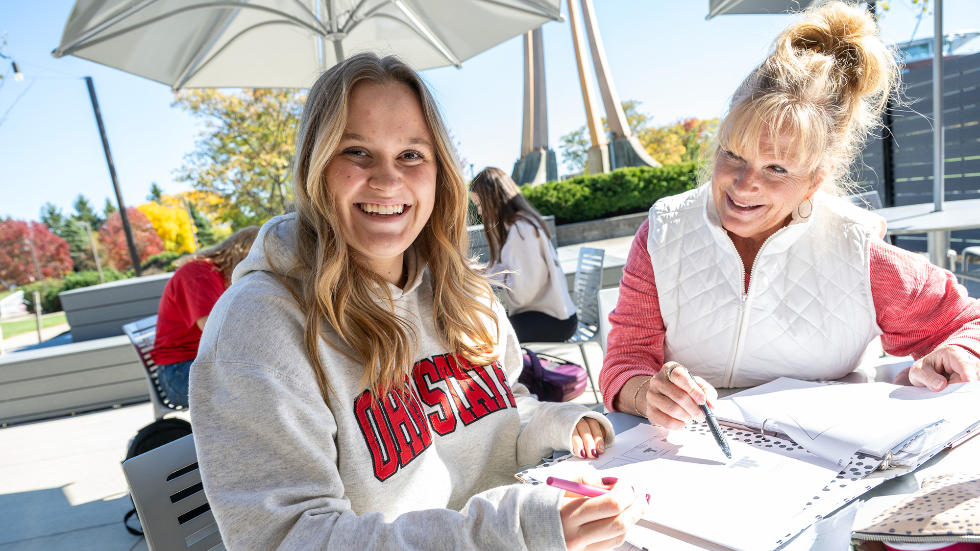 Two woman sit together at a table