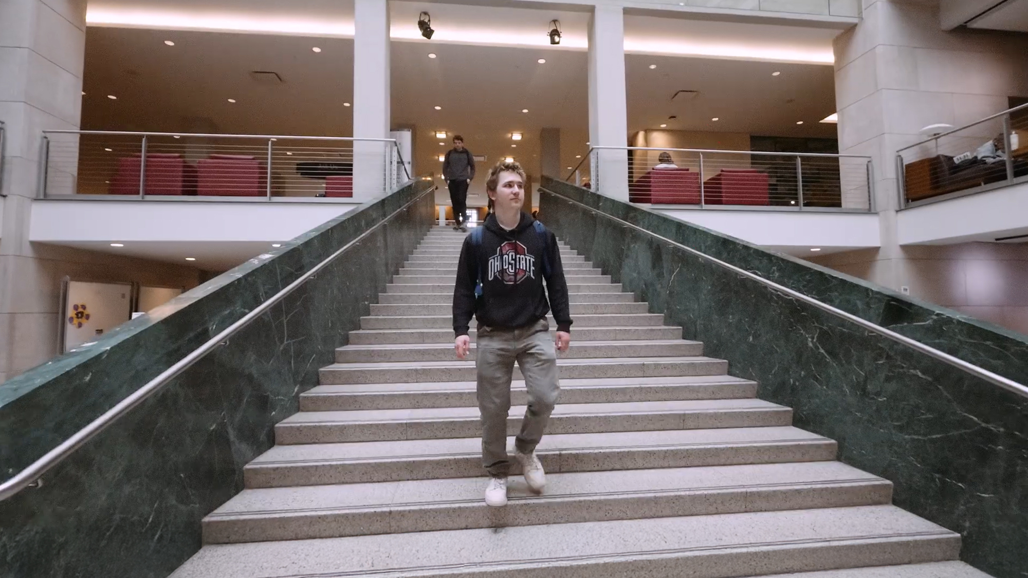 Ohio State student Jonah Clark walks down the stairs in Thompson Library.