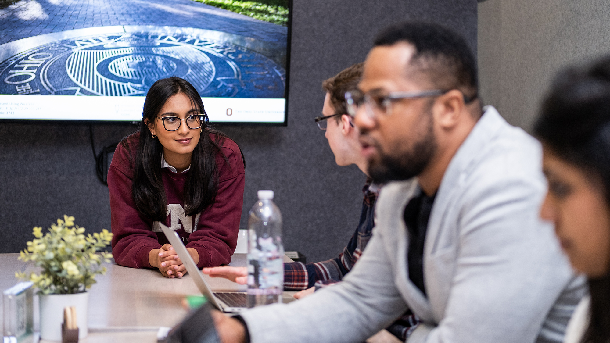 Ohio State student entrepreneurs discuss their work at a table