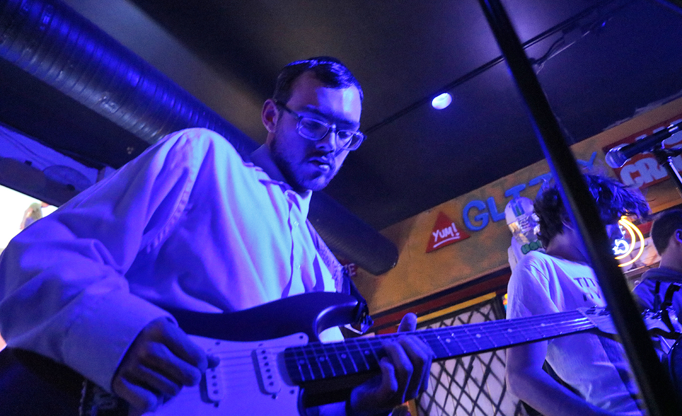 A student plays a guitar