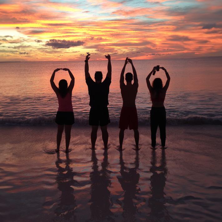 Four people in shadow spell OHIO on a sunsetting beach