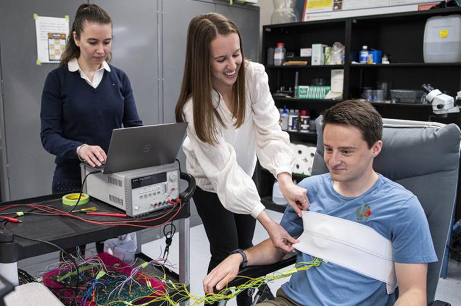 Prof. Asimina Kiourti (left) works with Ally Rice and fellow PhD student Connor Jenkins to test a wearable device in the ElectroScience Laboratory (photo by Logan Wallace).
