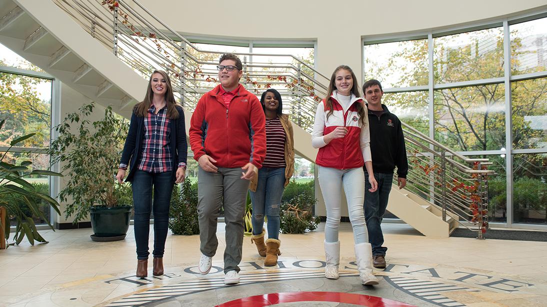Five students standing together in a building on the Marion campus