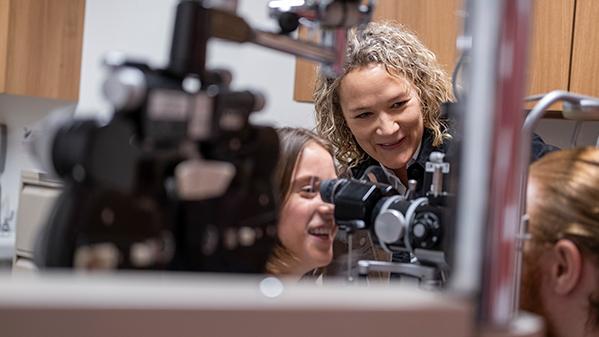 Melissa Bailey with optometry students in an exam room at the College of Optometry