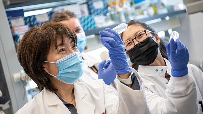 Professor Jiyoung Lee and graduate students in her water quality testing lab in the College of Public Health