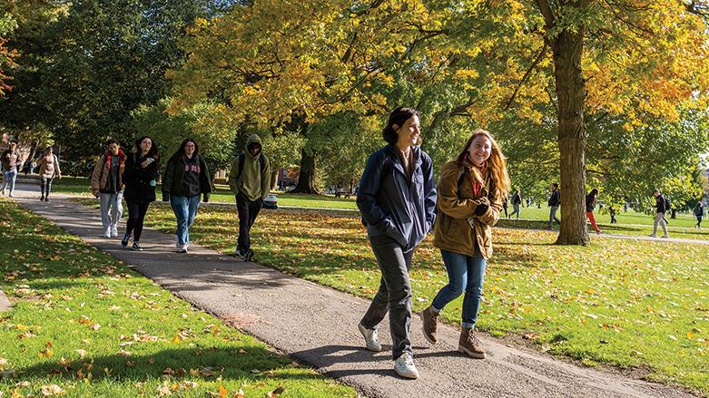 Students walking in the Oval on a sunny, fall day