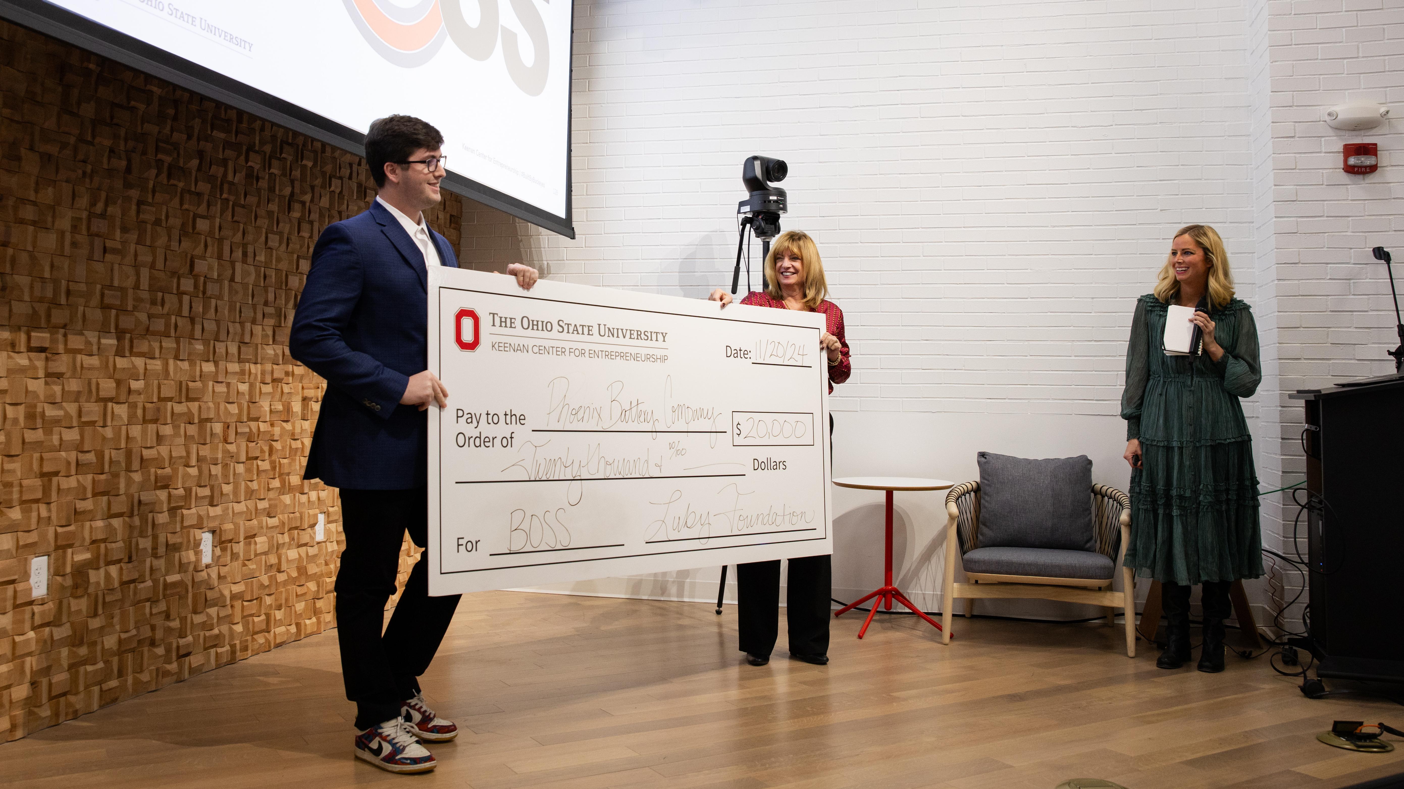 Jonah Mikesell receiving a giant check.