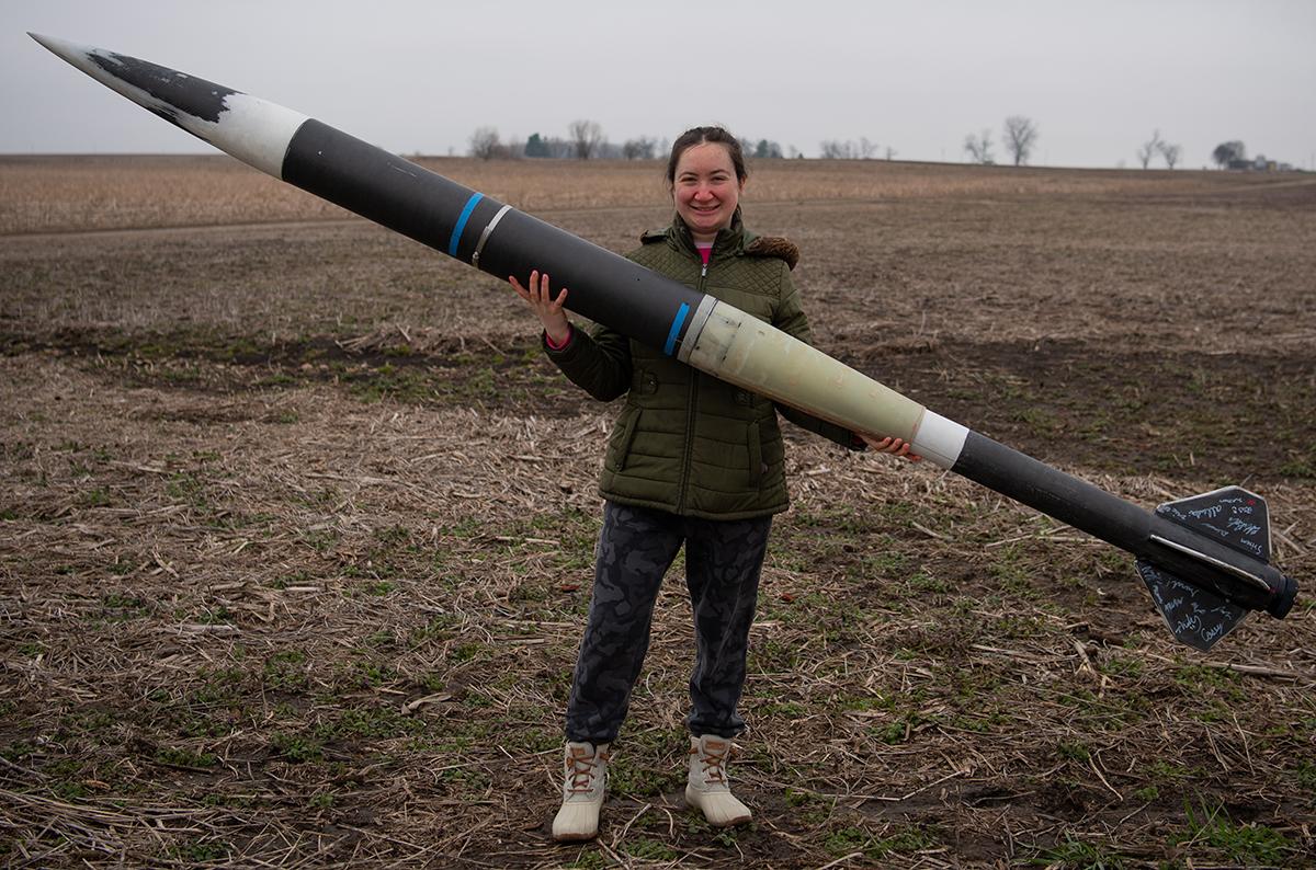 Lauren Clar holding a rocket.