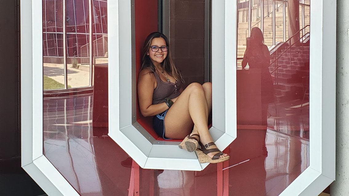 A student sits inside a Block O display