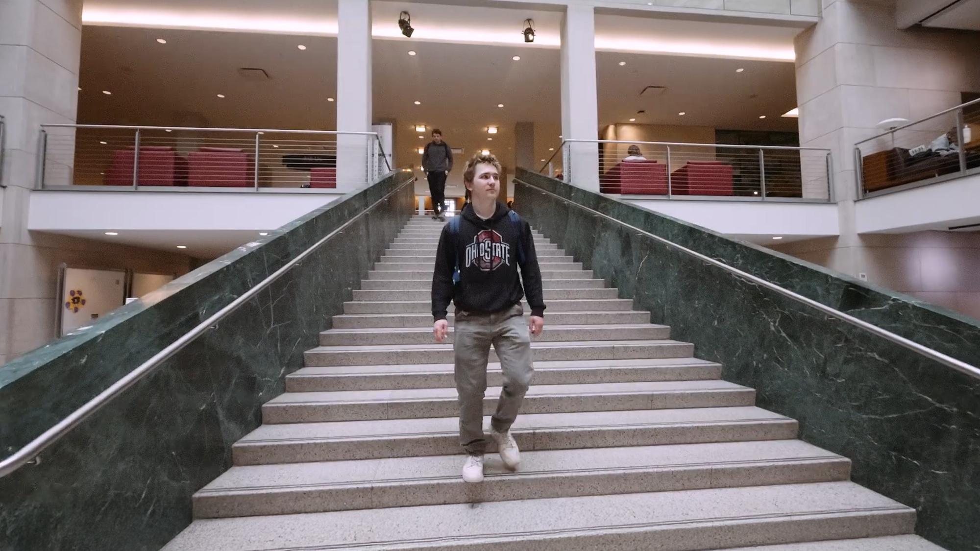 Ohio State student Jonah Clark walks down the stairs in Thompson Library.
