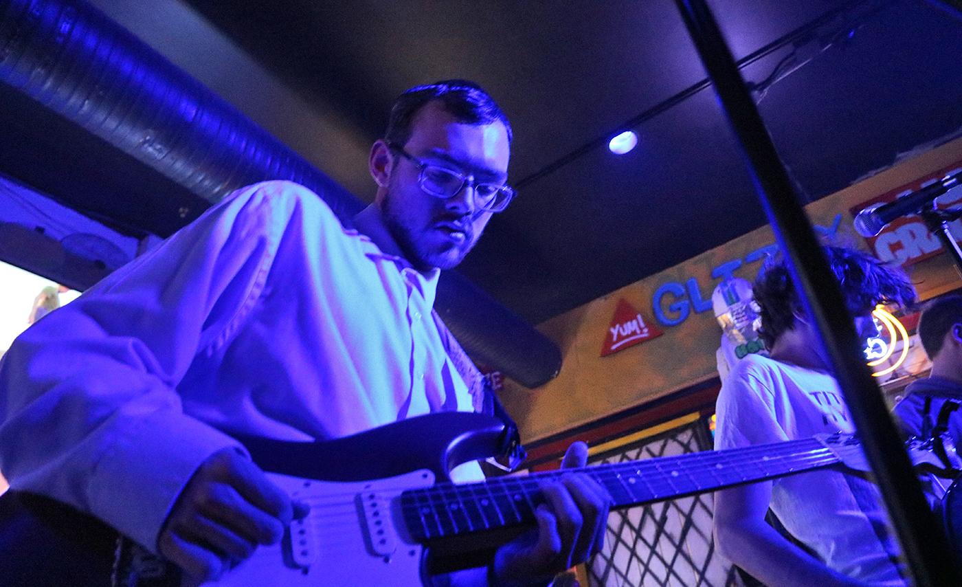 A student plays a guitar